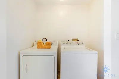 a kitchen with a stove and a white refrigerator at Beachwalk Resort Prime Location Balcony Gym in Hallandale Beach