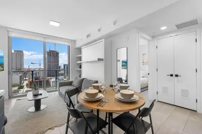 a living room with a table and chairs and a couch at High Style Living in the Heart of Miami in Miami