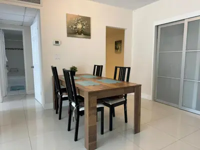a dining room with a wooden table and chairs at Ocean front 1 bedroom in Tropical Paradise in Hollywood