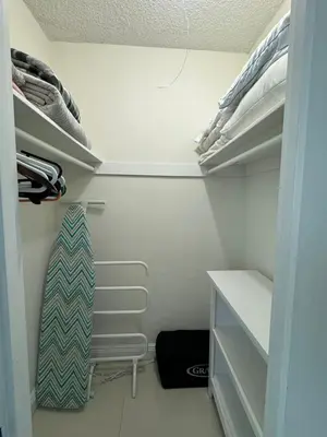 a walk in closet with a tie hanging on a shelf at Ocean front 1 bedroom in Tropical Paradise in Hollywood