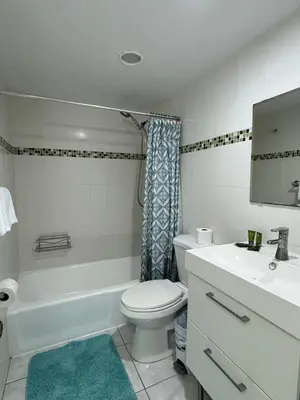 a bathroom with a white toilet and a sink at Ocean front 1 bedroom in Tropical Paradise in Hollywood