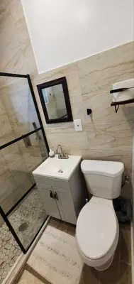 a bathroom with a toilet and a sink and a shower at Cosy new studio with yard space in Miami in Miami
