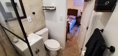 a small bathroom with a toilet and a sink at Cosy new studio with yard space in Miami in Miami
