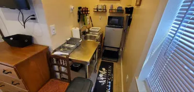 a small kitchen with a counter and a refrigerator at Cosy new studio with yard space in Miami in Miami