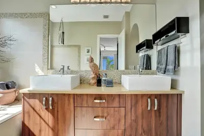 a bathroom with two sinks and a mirror at Tarpon River House - Heat Optional Pool - 4 bedrooms - 3 bathrooms - 1 miles to downtown FTL in Fort Lauderdale