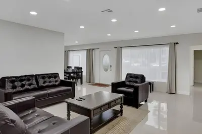 a living room with couches and a coffee table at Luxury Miami Villa in North Miami
