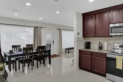 a kitchen and dining room with a table and chairs at Luxury Miami Villa in North Miami