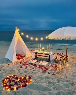 a tent on the beach with a table and candles at Million Dollar Waterfront Penthouse in Hallandale Beach