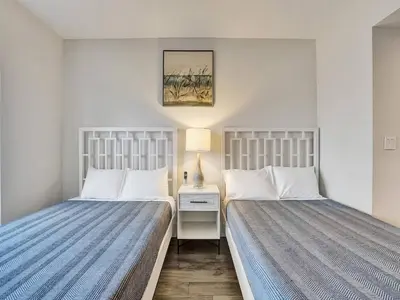 two beds sitting next to each other in a bedroom at Luxury Waterfront Suite with Great Views in Hallandale Beach