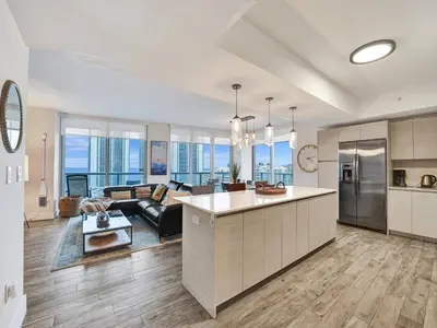 a large kitchen and living room with a couch at Luxury Waterfront Suite with Great Views in Hallandale Beach