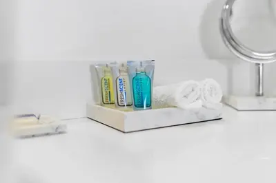 a bathroom counter with toothbrushes and toothpaste at Top Floor Luxury Penthouse with Private Roof Deck in Hallandale Beach