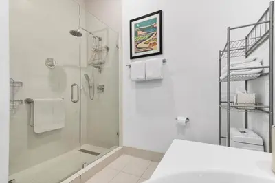 a white bathroom with a shower and a sink at Top Floor Luxury Penthouse with Private Roof Deck in Hallandale Beach
