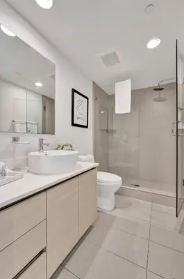 a bathroom with a sink and a toilet and a shower at Luxury Waterfront Suite in Hallandale Beach