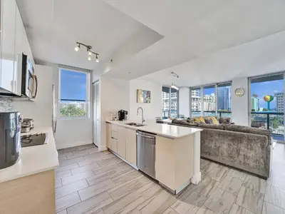 an open kitchen and living room with a couch at Luxury Waterfront Suite in Hallandale Beach