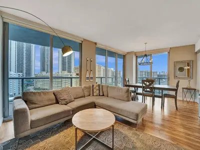a living room with a couch and a table at Luxury Waterfront Condo in Hallandale Beach