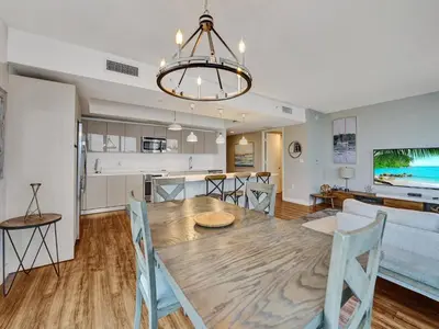 a dining room and kitchen with a table and chairs at Luxury Waterfront Condo in Hallandale Beach