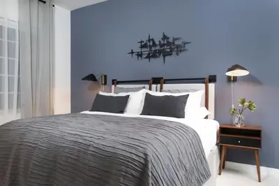 a bedroom with a large bed with a blue wall at Kasa Collins Park Miami Beach Convention Center in Miami Beach