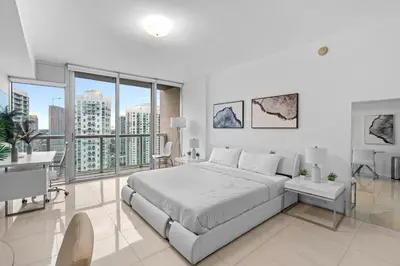a white bedroom with a large bed and large windows at Studio in Miami Brickell Business District ICON Residences in Miami