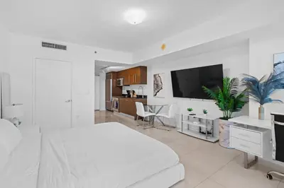 a white bedroom with a white bed and a tv at Studio in Miami Brickell Business District ICON Residences in Miami