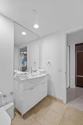 a white bathroom with a sink and a toilet at Studio in Miami Brickell Business District ICON Residences in Miami