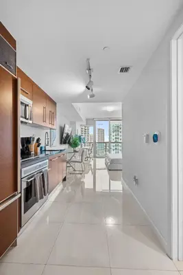 a large white kitchen with a table and a dining room at Studio in Miami Brickell Business District ICON Residences in Miami