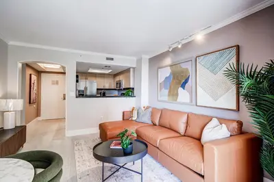 a living room with a couch and a table at Coconut Grove Beauty 1 bedroom Bayview Condo with Free Parking in Miami