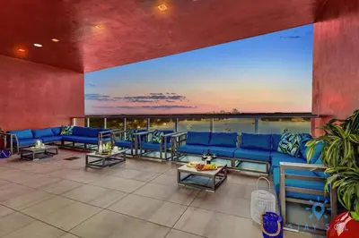 a large living room with blue couches and tables at Hollywood Bliss Studio Rooftop Pool in Hollywood