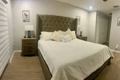 a bedroom with a large bed with a large headboard at Cozy 2 Bedroom Modern Farmhouse in Miami in Tamiami