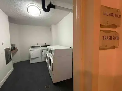 a small kitchen with a washer and dryer in it at 7th FL Ocean view spacious 1 bedroom in Hollywood