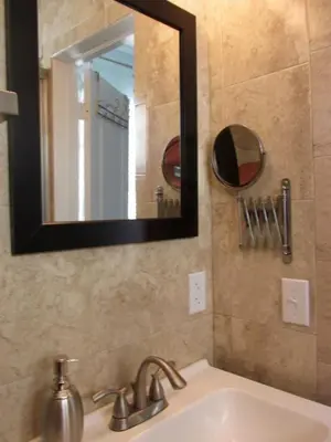 a bathroom with a sink and a mirror at Lux Condo by the Beach in Miami Beach