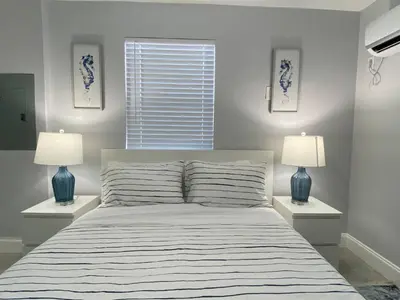 a bedroom with a large bed with two lamps at Annas Peaceful mini Luxury suite in Fort Lauderdale