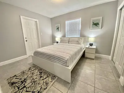 a bedroom with a bed and a window at Anna's peaceful Getaway Luxury Suite in Fort Lauderdale