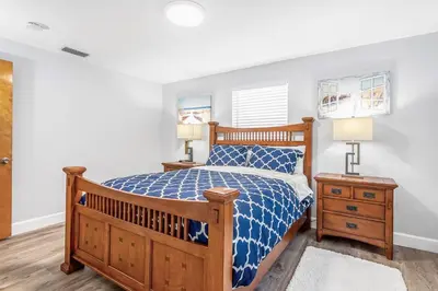 a bedroom with a wooden bed and two lamps at Luxury home in Fort Lauderdale