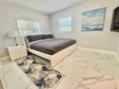 a bedroom with a bed and a marble floor at Mazor luxury one bedroom vacation Home in Fort Lauderdale