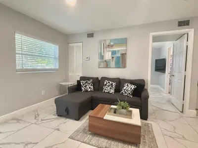 a living room with a couch and a coffee table at Mazor luxury one bedroom vacation Home in Fort Lauderdale