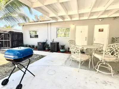 a patio with a grill and a table and chairs at Mazor luxury one bedroom vacation Home in Fort Lauderdale