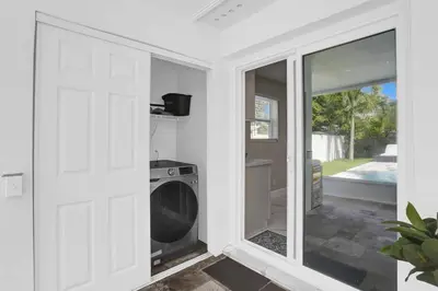 a kitchen with a washer and dryer in a room at Yehudas Tropical Villa with Heated Infinity Pool in Hollywood