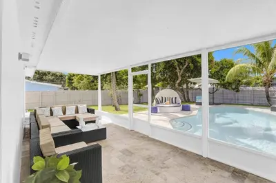 a house with a swimming pool and a patio at Yehudas Tropical Villa with Heated Infinity Pool in Hollywood