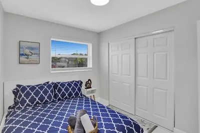 a bedroom with a blue bed and a white door at Yehudas Tropical Villa with Heated Infinity Pool in Hollywood