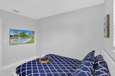 a room with a bed and a picture on the wall at Yehudas Tropical Villa with Heated Infinity Pool in Hollywood