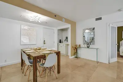 a kitchen and dining room with a table and chairs at Cozy Beachfront 2 BDR Miami Beach Condo 1114 in Miami Beach