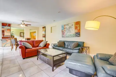 a living room with couches and a table at Spacious House near Fort Lauderdale - Minutes from Beach in Plantation