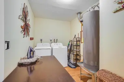 a kitchen with a stove and a table in a room at Spacious House near Fort Lauderdale - Minutes from Beach in Plantation