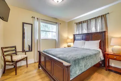 a bedroom with a bed and a chair and a window at Spacious House near Fort Lauderdale - Minutes from Beach in Plantation