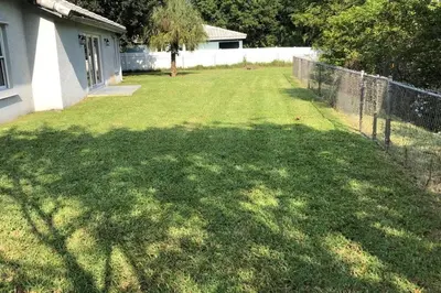 a yard with a fence and a grass field at Spacious House in Fort Lauderdale - Minutes from Beach in Fort Lauderdale