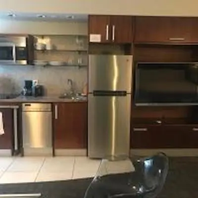 a kitchen with a stainless steel refrigerator and a sink at Congress Ocean Drive in Miami Beach