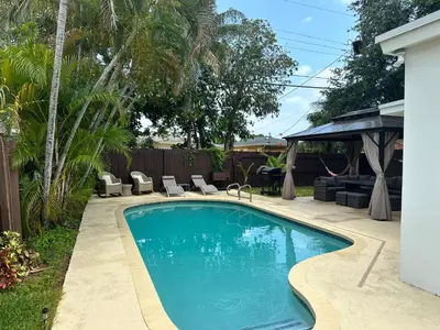 a swimming pool in the backyard of a house at Pool house 3 bedroom 2 bathroom in North Miami Beach