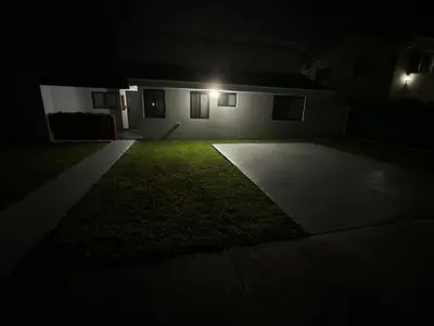 a house with a grassy yard at night at Westchester Garden in Miami