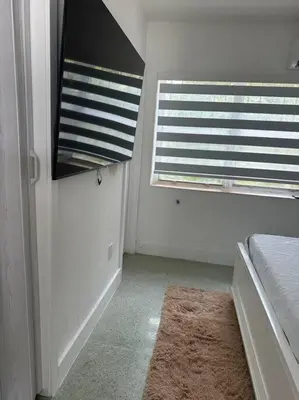a white room with a window and a rug at Villa Clara Gold-Little Havana in Miami