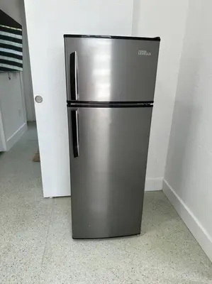 a stainless steel refrigerator in the corner of a room at Villa Clara Gold-Little Havana in Miami